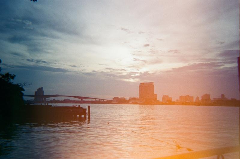 a film-burned image of a river at sunset